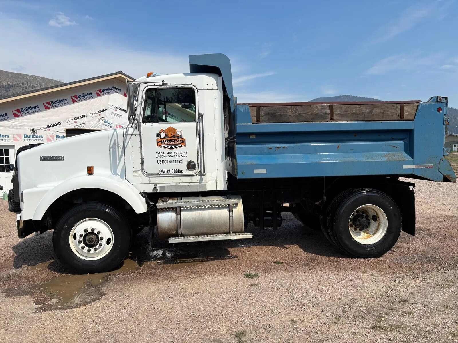 Handy's Construction dump truck with the company logo on the door